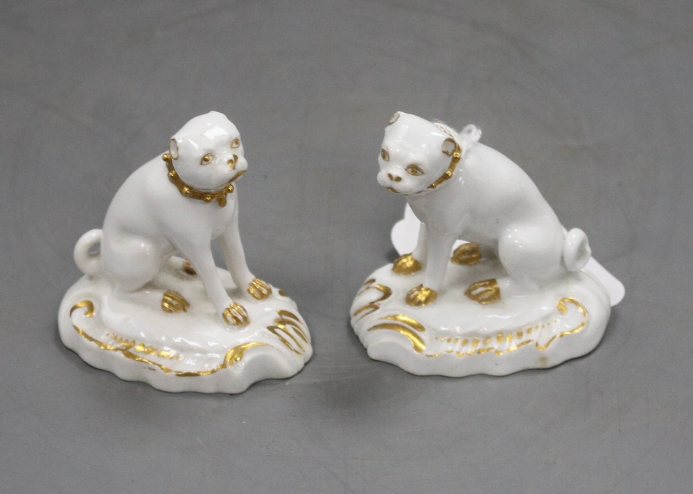 A pair of Derby gilt and white seated figures of pug dogs, c.1830, H. 5.7cm